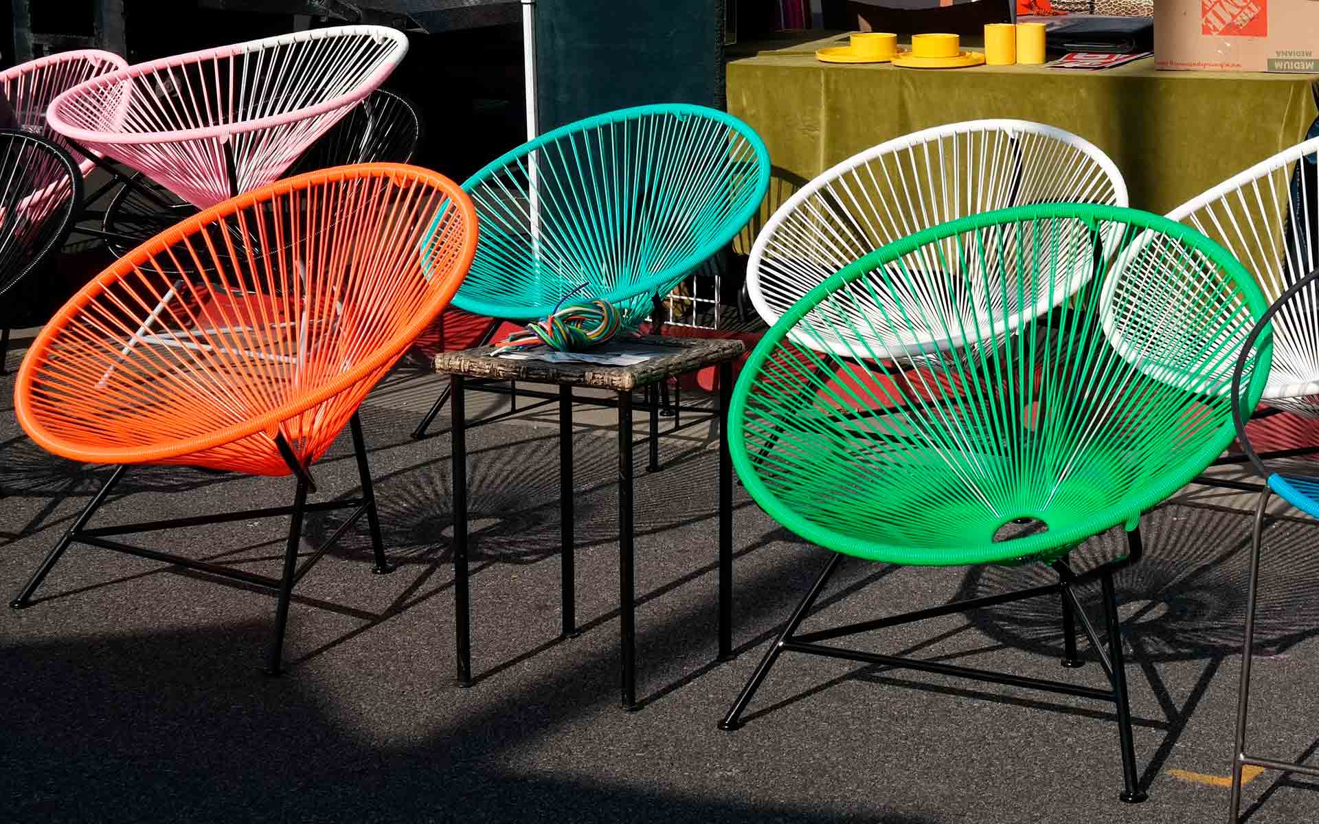 brightly coloured plastic round chairs for sale at the Rose Bowl flea market.