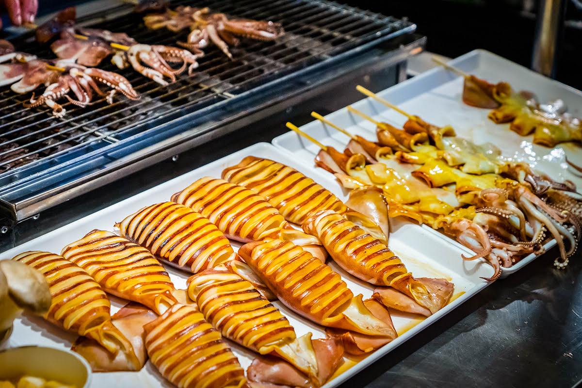 Seafood on sticks, grill and on a try, ready to be cooked.