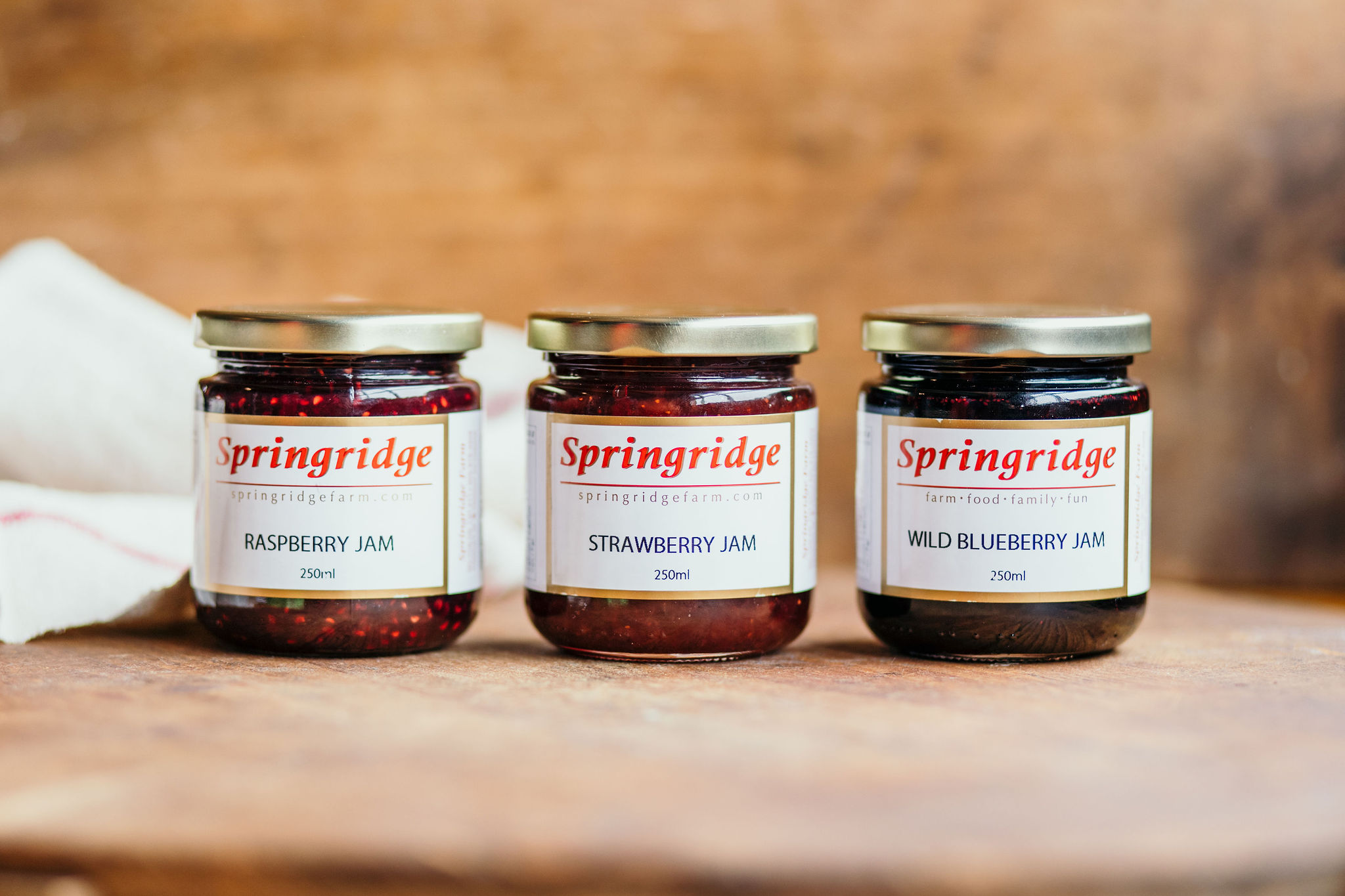 3 jars of jam in a row from Springridge farm - raspberry, strawberry and wild blueberry.