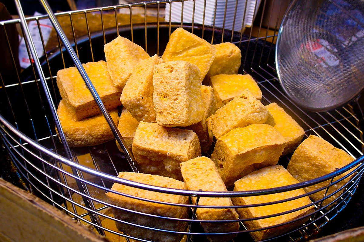 Food in a basket at a night market.