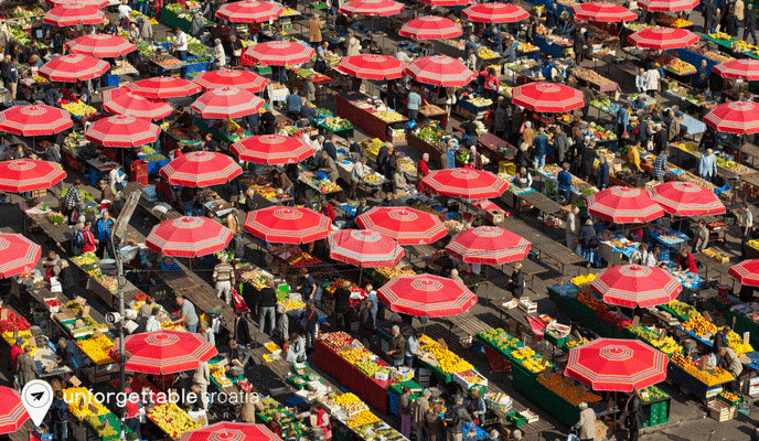Image of brightly coloured umbrella stands at stalls in the Dolac Market